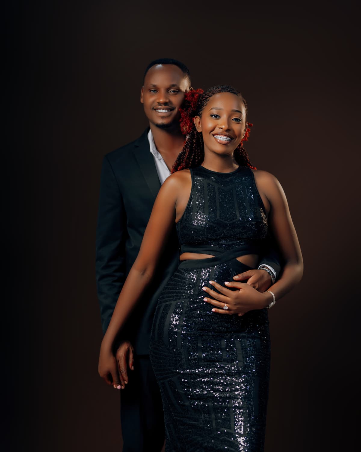 Celine and Khalim smiling together in a studio portrait